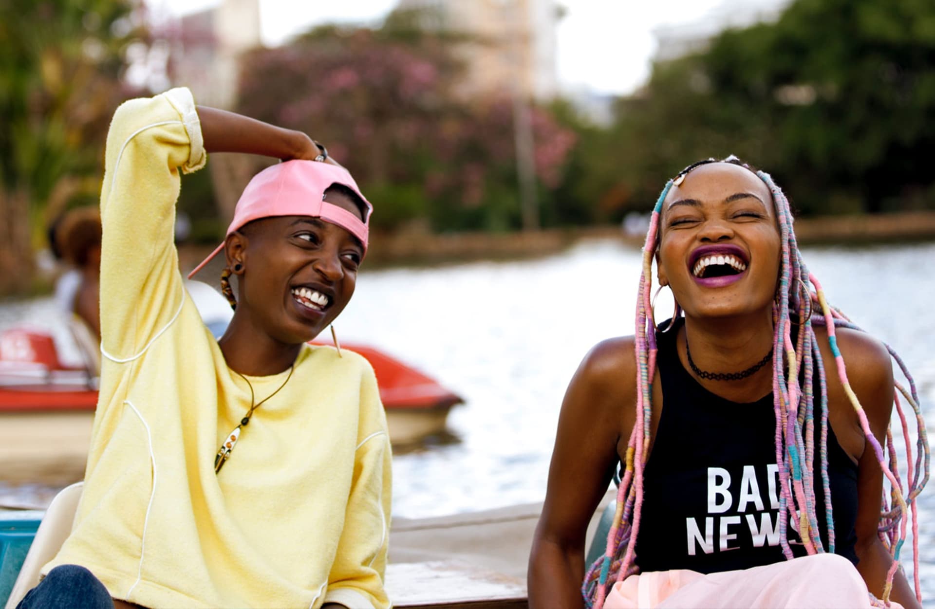 Kena (right) and Ziki (left) laughing on a pedal boat.